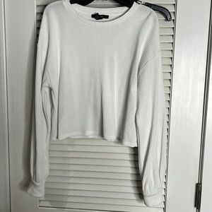 Cream long sleeve crop top.